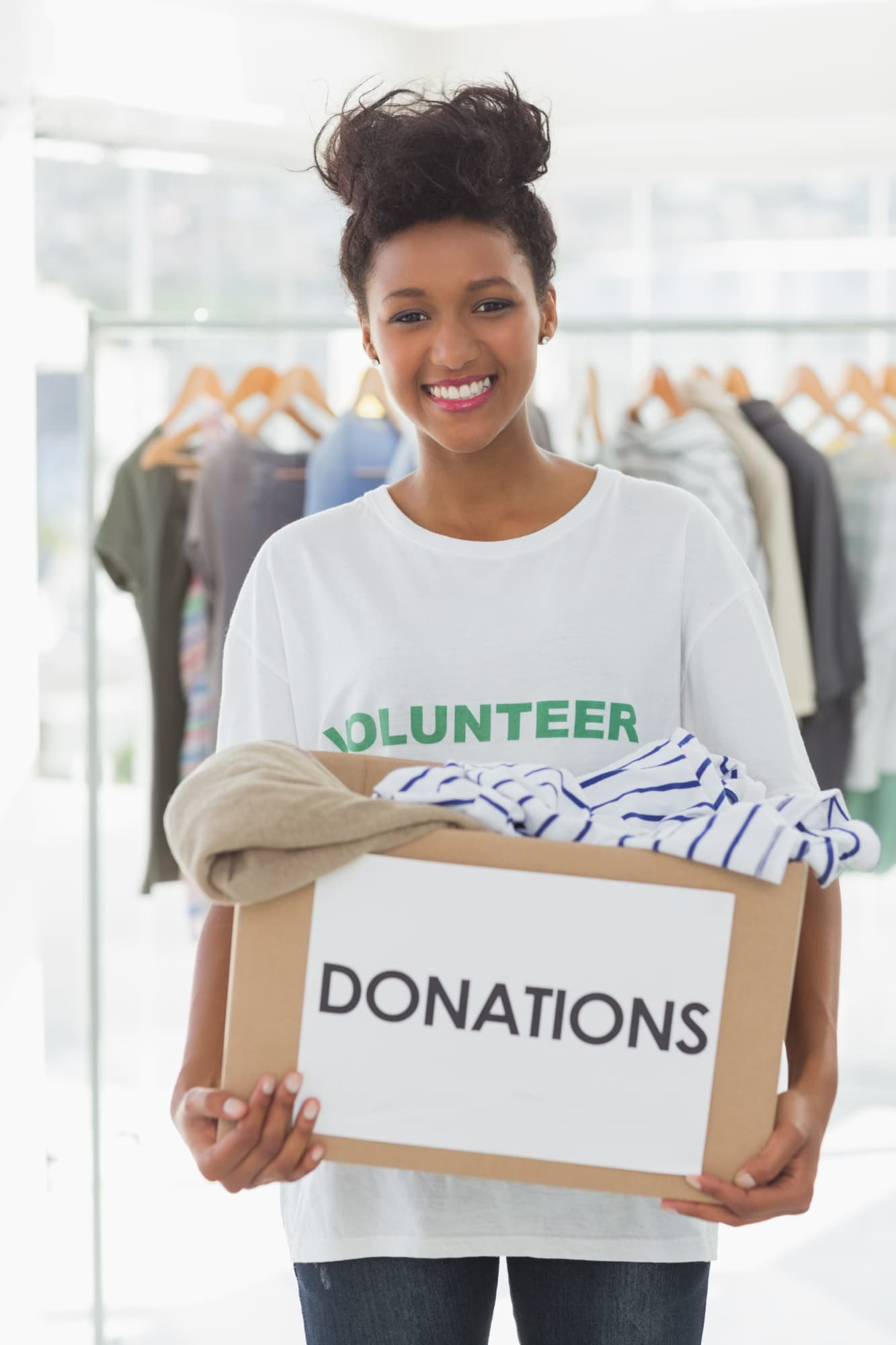 Volunteer holding a box of donated clothing